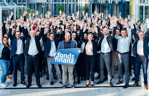 Mitarbeiter der Fonds Finanz in München aus verschiedenen Fachabteilungen des Unternehmens, die für ein Gruppenfoto posieren